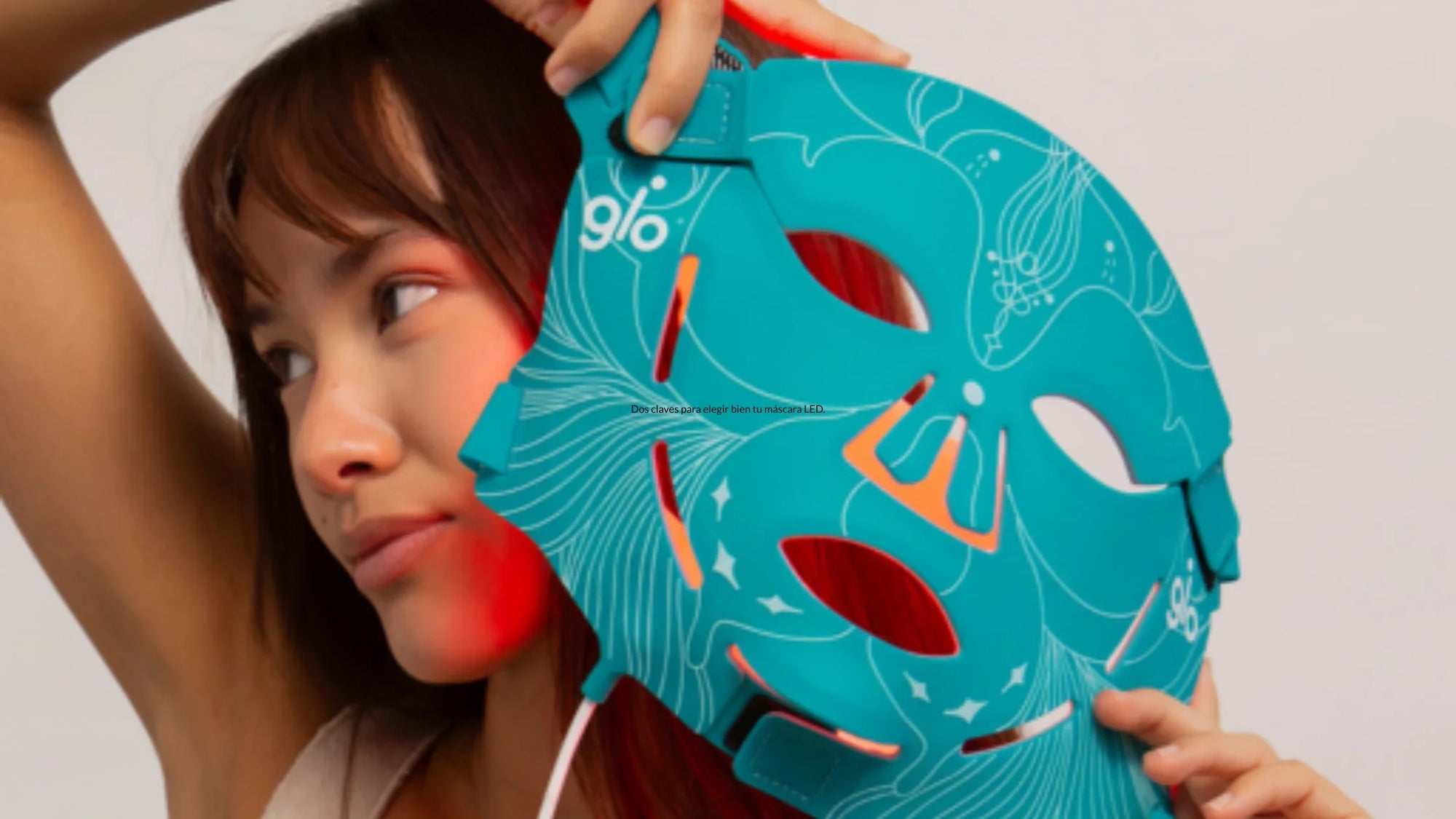 Woman holidng the GLO MASK face LED mask